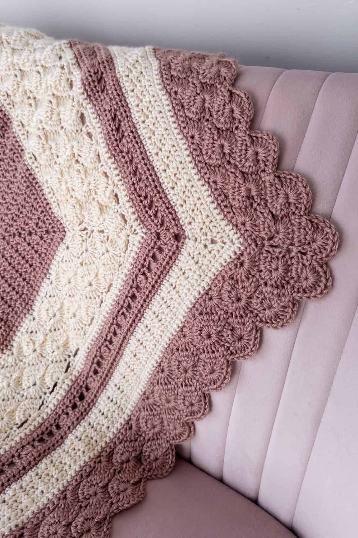 Textured crochet blanket on a light pink chair