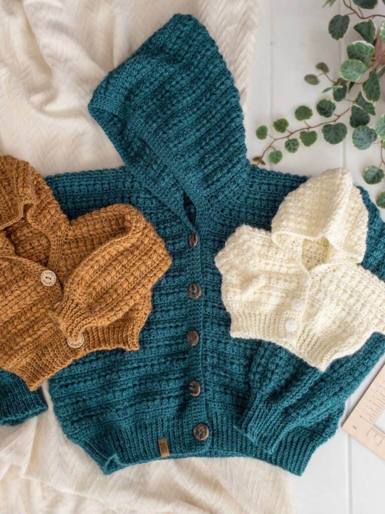 Three crochet cardigans in various colors and sizes, displayed side by side on a white background.