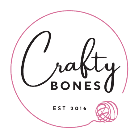Crafty Bones logo featuring the words “Crafty Bones” inside a circular outline with a ball of yarn and trailing thread at the bottom right.